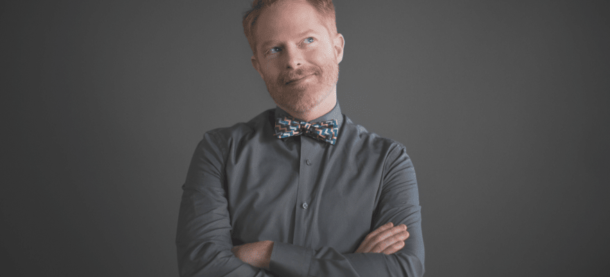 Jesse Ferguson website home page with studio photo of him in a grey shirt and colorful bowtie